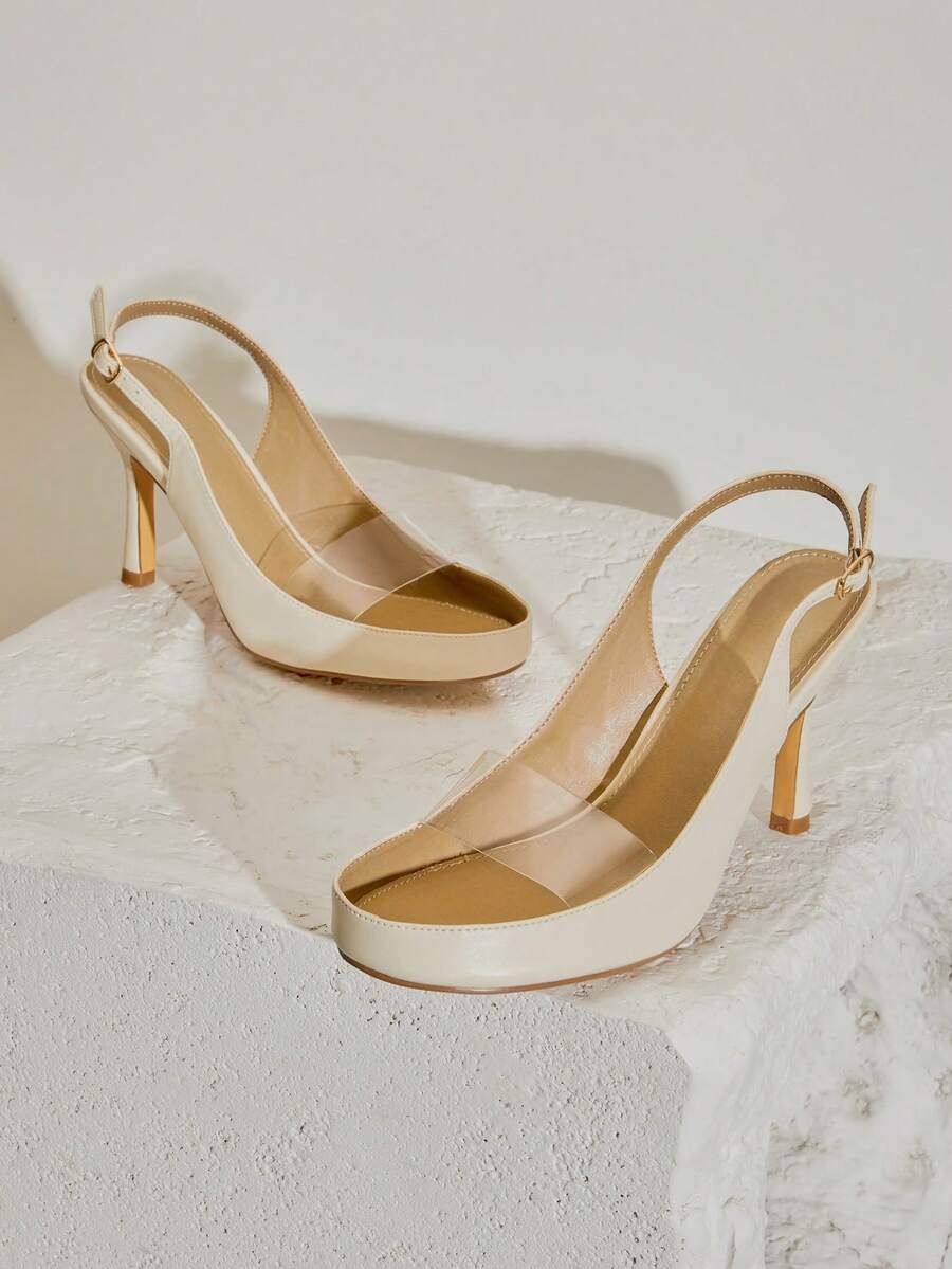 Ivory transparent-vamp slingback stilettos on a textured pedestal