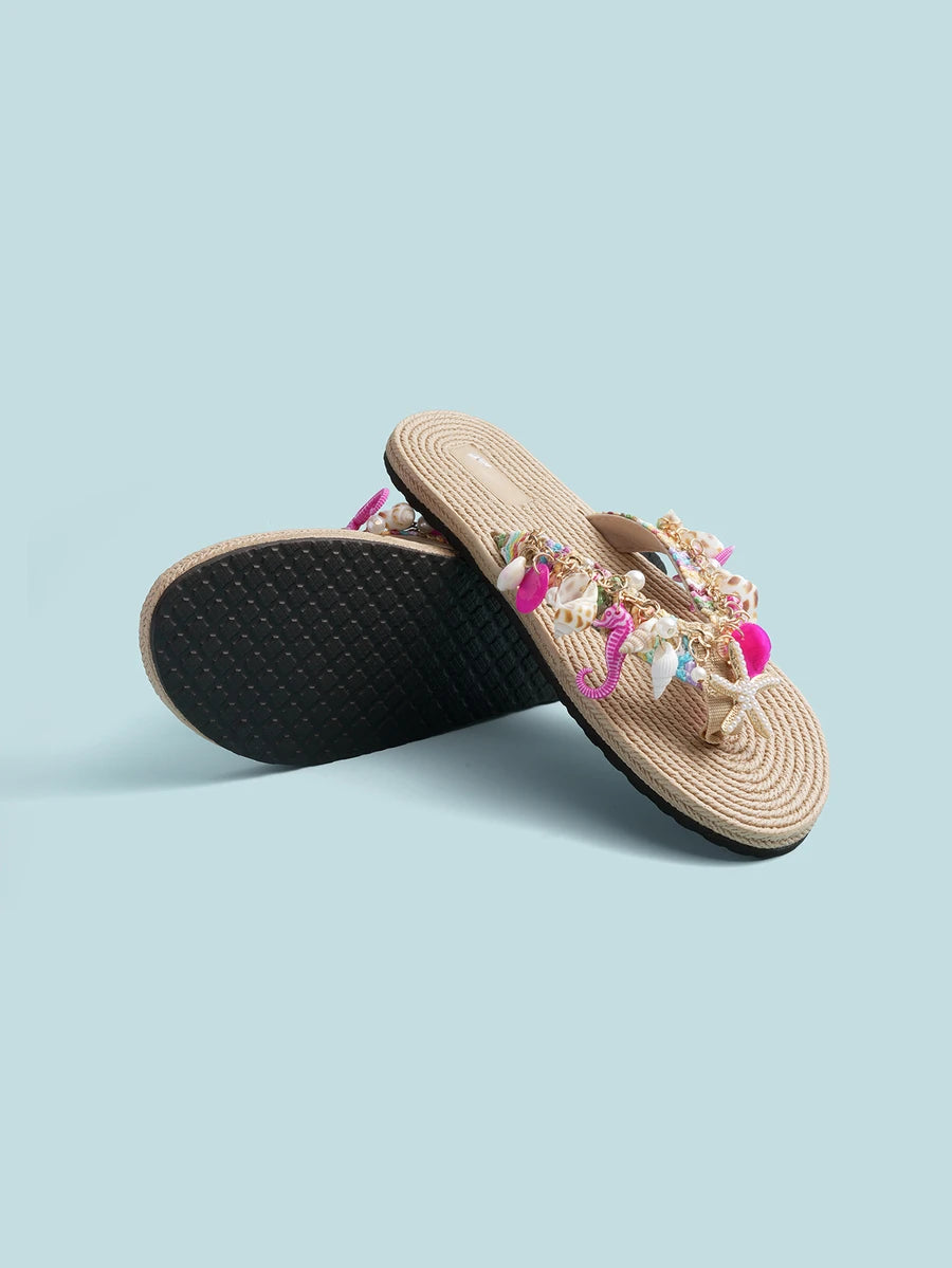 Product and outsole view of embellished thong sandals with marine-themed charms