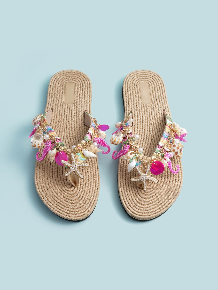 Overhead pair of beige bohemian thong sandals with starfish and pearl-like charms