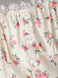 Close-up of floral lace neckline with pearl-style buttons