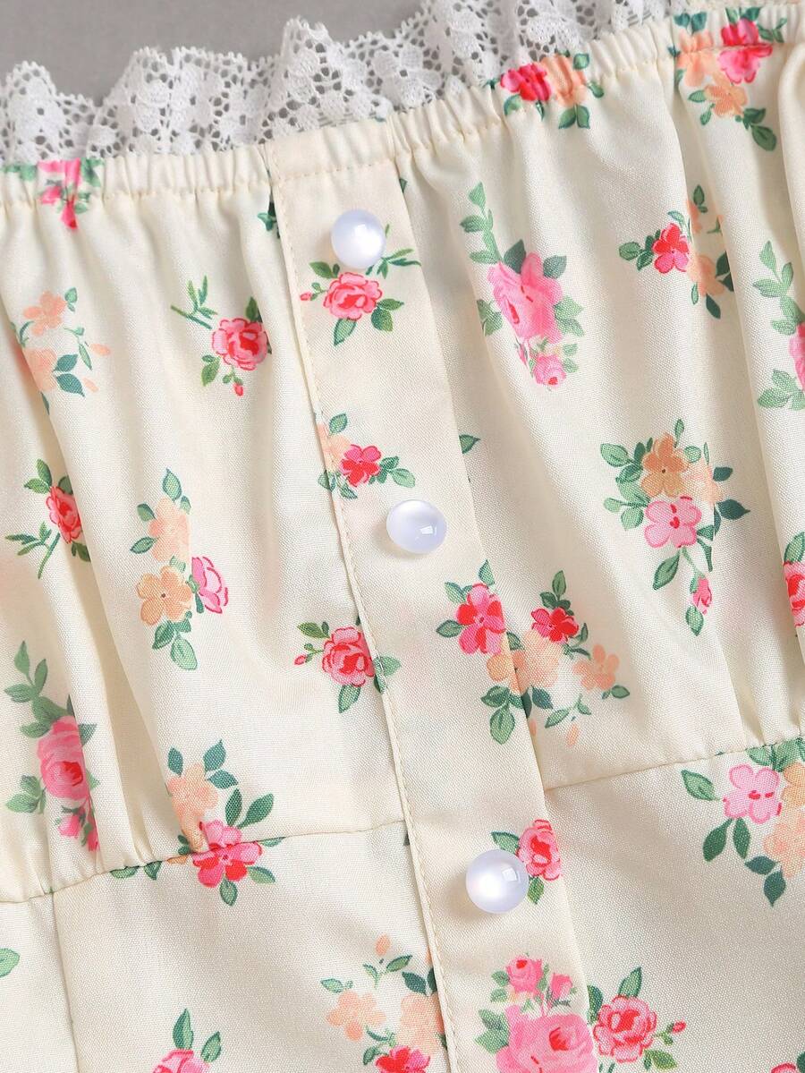Close-up of floral lace neckline with pearl-style buttons