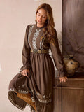 Close-up view of vintage bohemian brown maxi dress with frill trim and embroidered hem for autumn/winter with maxi dress silhouette for daily wear