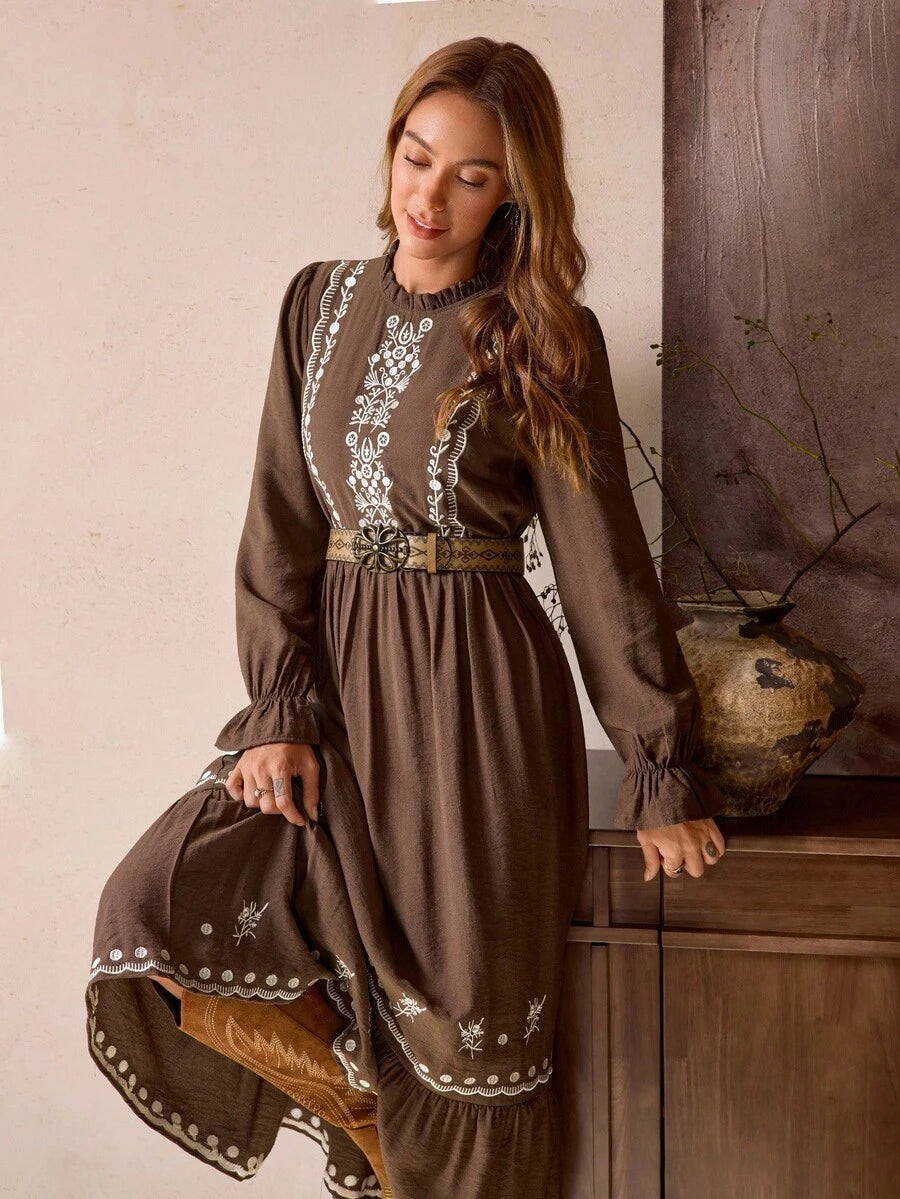 Close-up view of vintage bohemian brown maxi dress with frill trim and embroidered hem for autumn/winter with maxi dress silhouette for daily wear