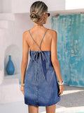 Back view of dark-wash denim sundress with crossed tie-back bow