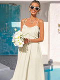 Close-up cream ruffle bust sundress with bouquet and sunglasses