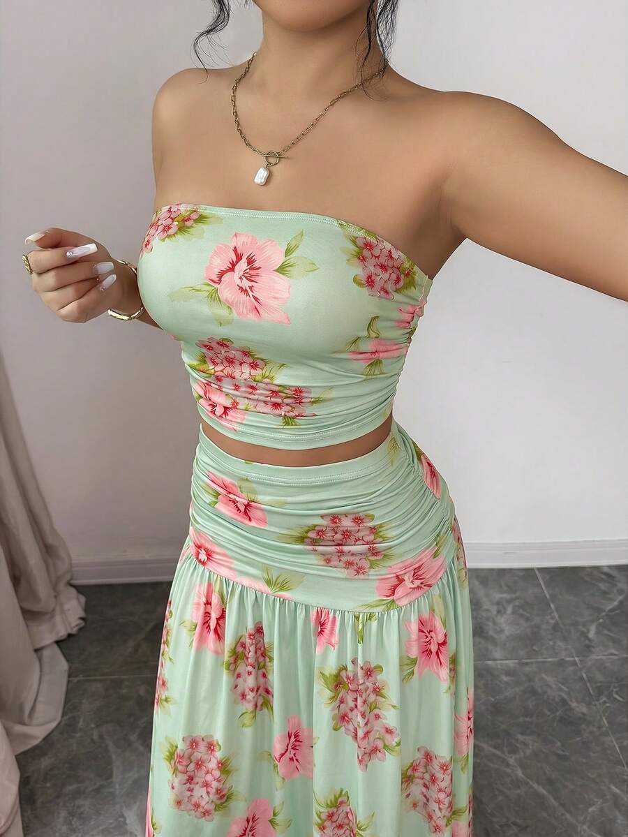 Close detail view of floral strapless crop top and maxi skirt set showing visible color, print, and silhouette