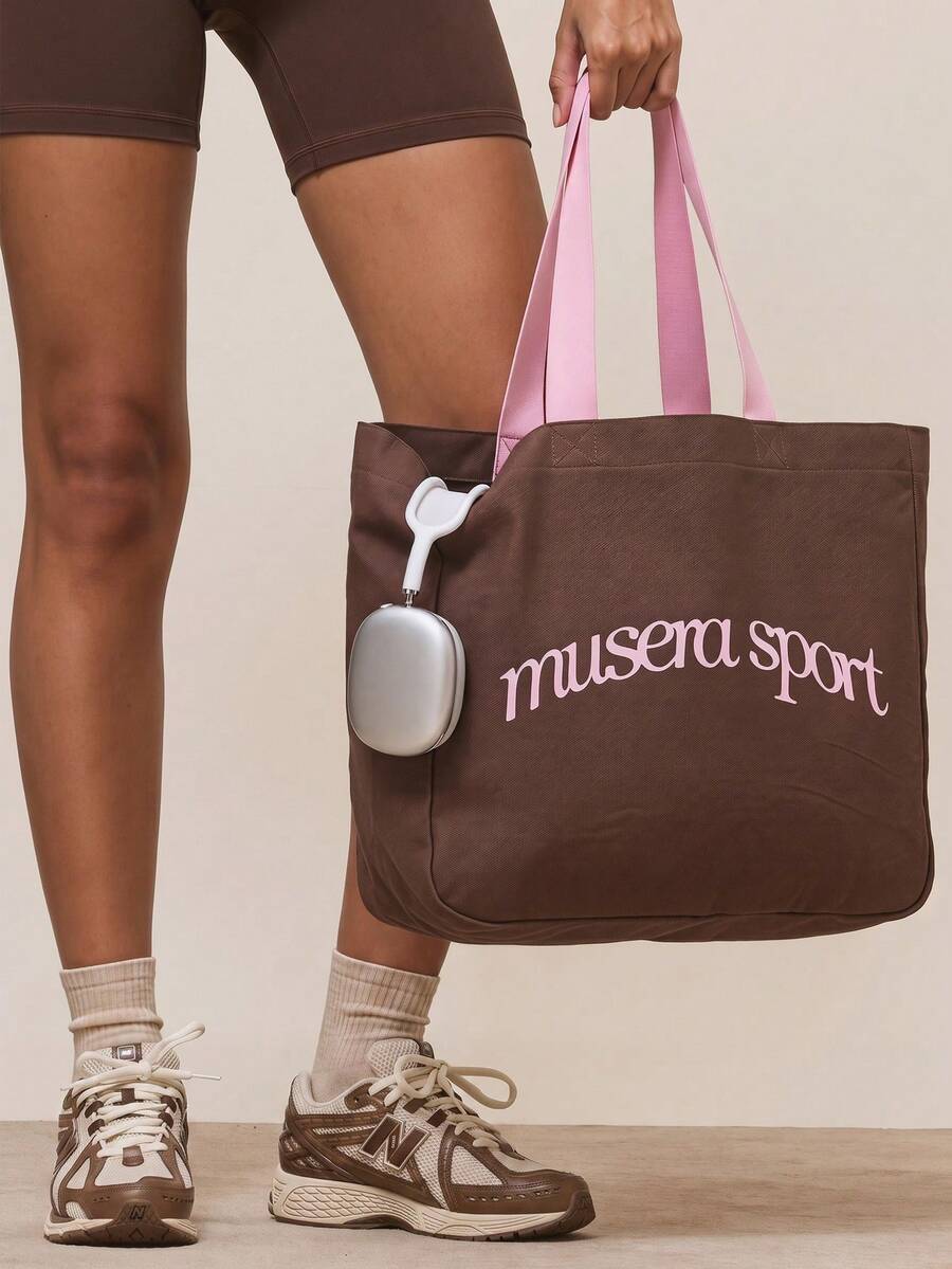 Pink canvas sport tote bag with brown musera sport logo and shoulder straps