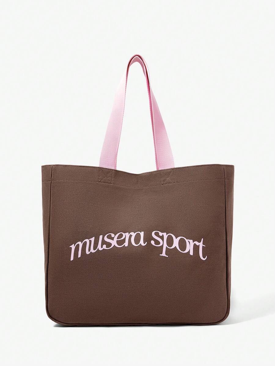 Close view of pink oversized shopper bag showing front logo and canvas texture