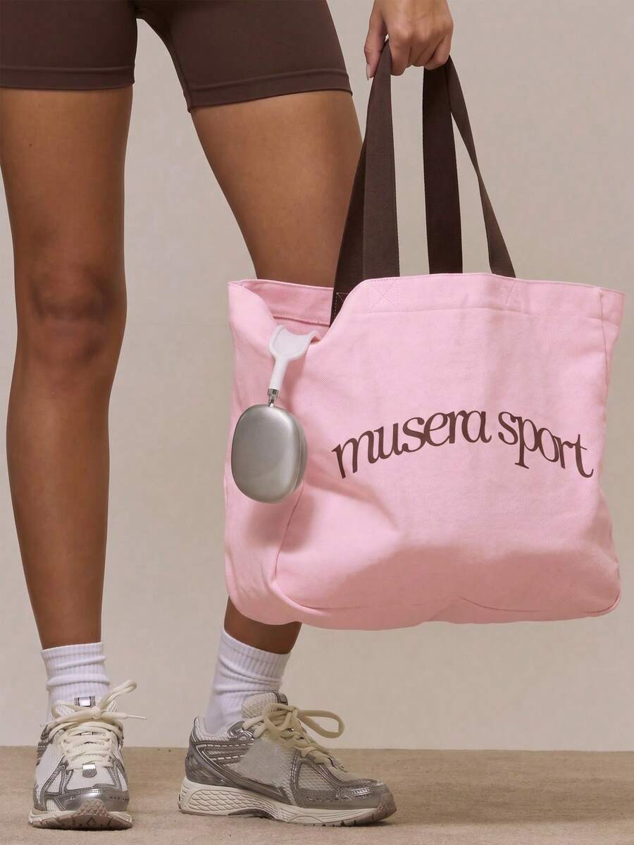 Interior view of canvas sport tote bag with bottle phone headphones and laptop