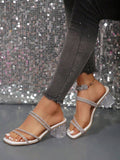 Side view of white silver rhinestone mule sandals with clear heel