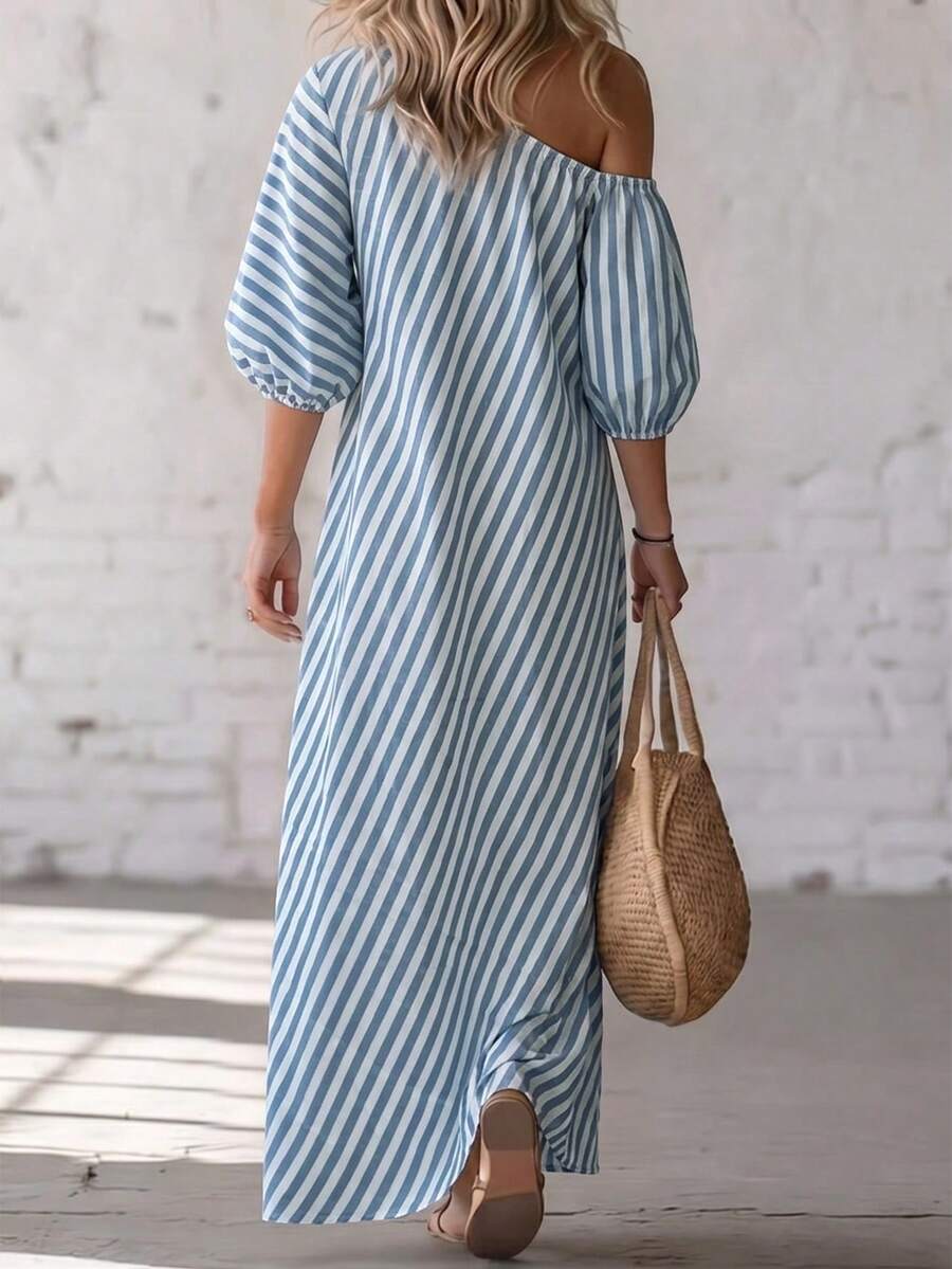 Back view of blue striped maxi dress with exposed shoulder and loose long shape