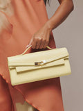 Pale yellow structured top handle clutch mini bag with gold turn lock clasp