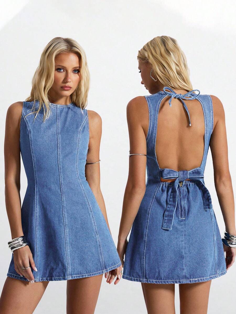 Front and back view of medium-wash denim mini dress showing open back and waist bow