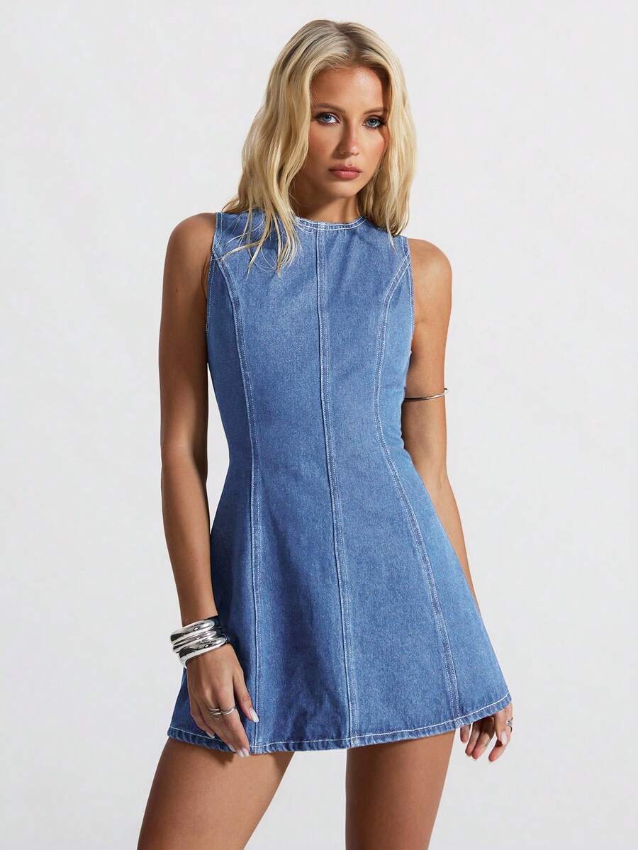 Front studio view of medium-wash sleeveless denim mini dress with fitted waist and flared skirt