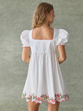 White mini dress with pink and green floral embroidery