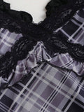 Close-up of layered black lace neckline and plaid frill trim