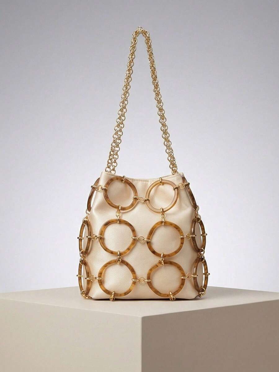 Tortoiseshell acrylic ring bucket bag with cream satin pouch and gold links