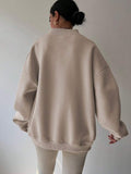 Back view of apricot oversized sweatshirt with longline rib-knit hem