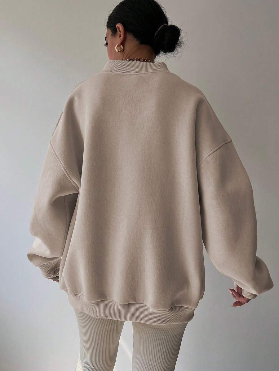 Back view of apricot oversized sweatshirt with longline rib-knit hem