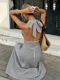 Back view of striped halter maxi dress with open back