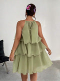Back view of sage green halter dress with tie detail