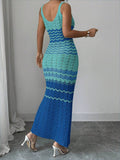 Back view of turquoise blue crochet maxi dress with fitted shape and flared hem
