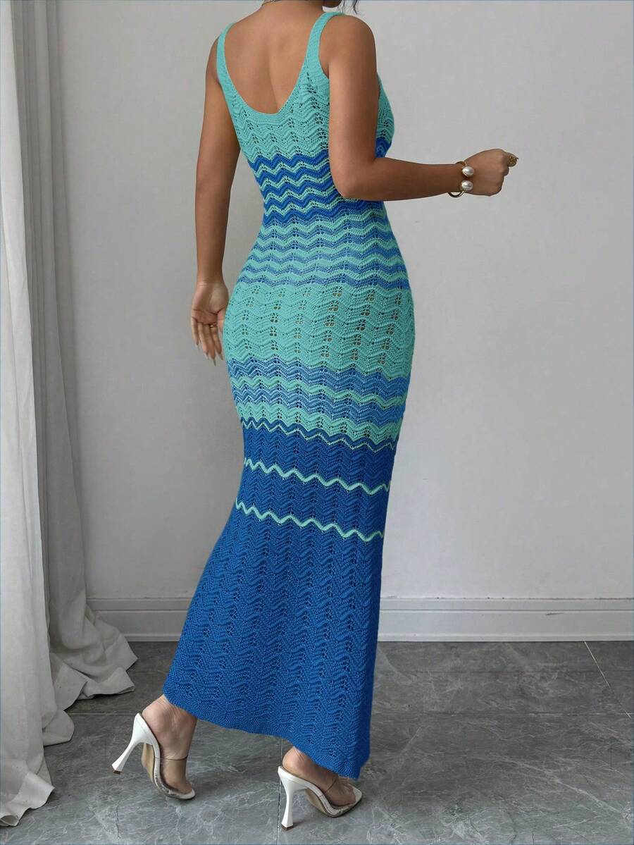 Back view of turquoise blue crochet maxi dress with fitted shape and flared hem
