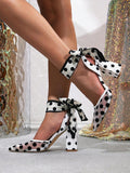 16 media show women polka dot pointed toe pumps in white/black variants with ankle bow wrap or buckle strap, stiletto or chunky block heel, sheer mesh panels on some styles. image 15