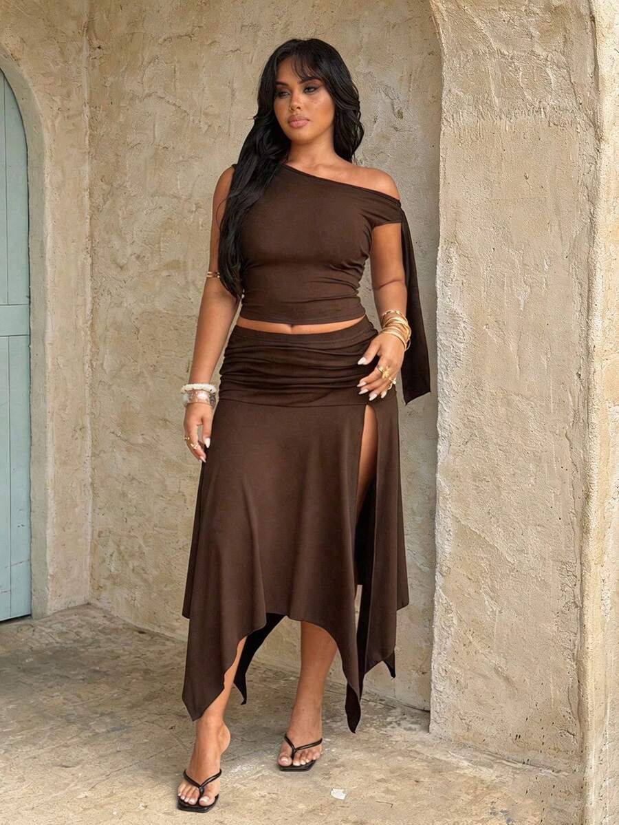 plus size two-piece skirt set in black olive green and brown with asymmetric one-shoulder crop top, draped shoulder tie panel, high waist ruched midi skirt, handkerchief hem and high thigh slit image 10