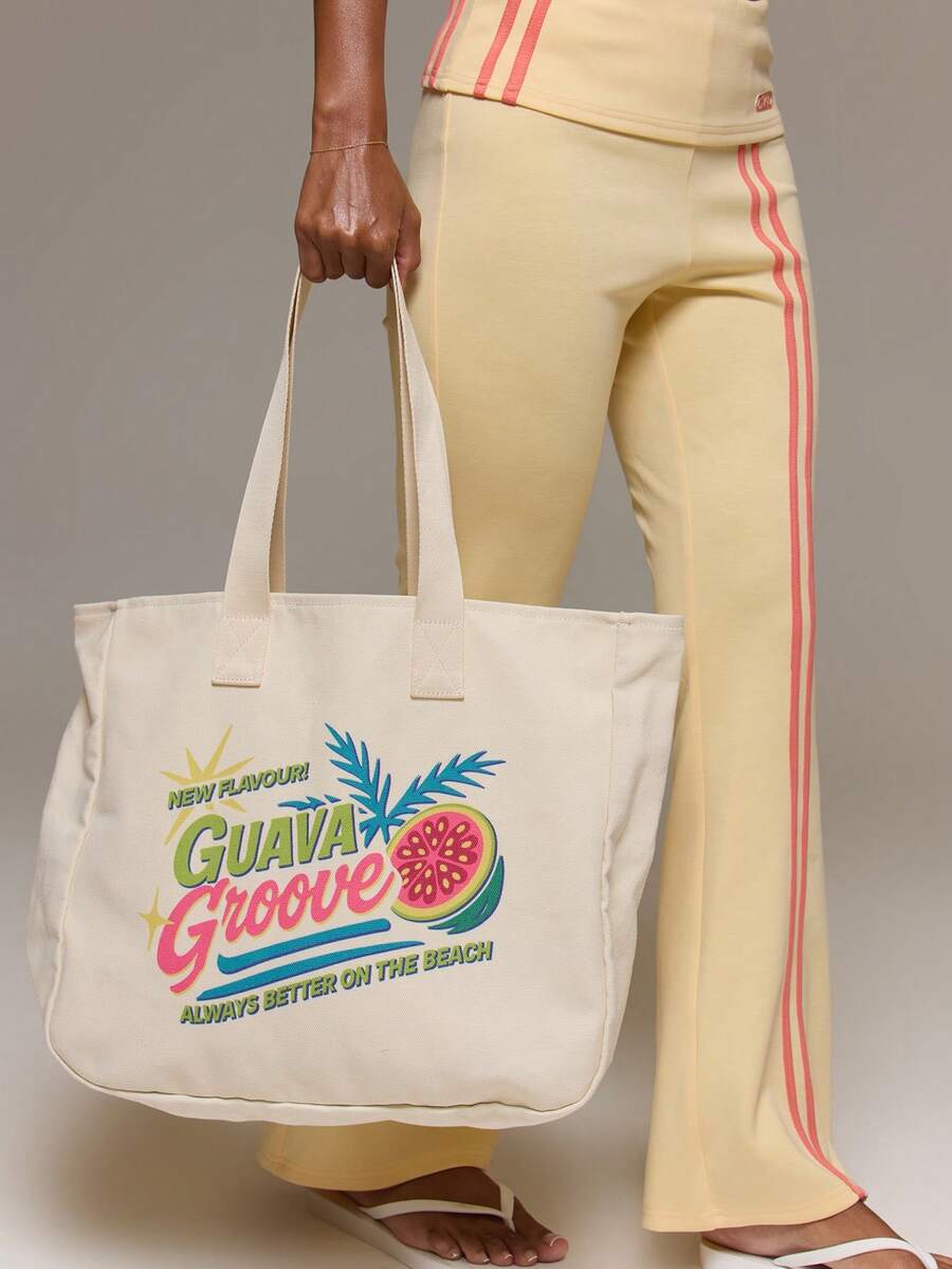 Cream Guava Groove canvas tote bag with tropical fruit graphic and brown shoulder straps