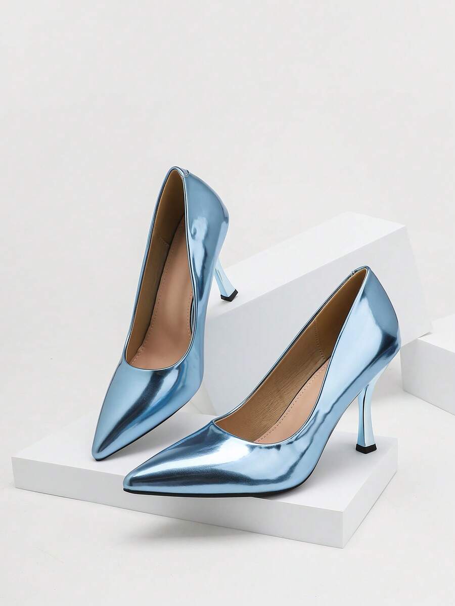 Front three-quarter view of metallic blue pointed-toe stiletto pumps