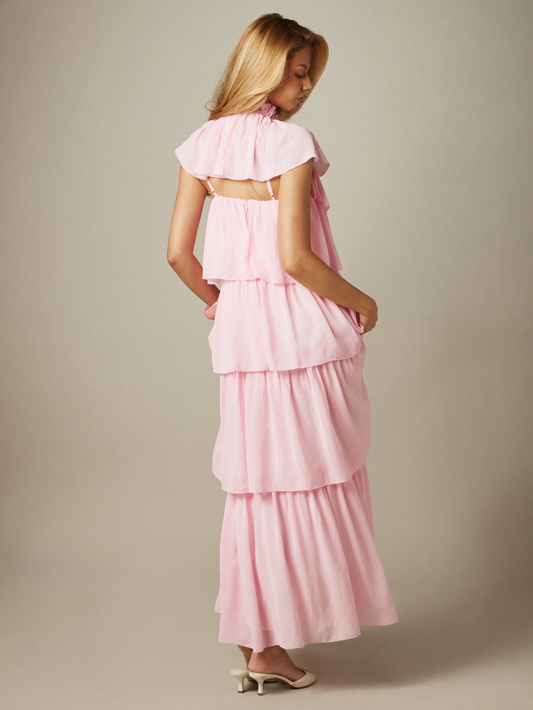 Front view of pink high neck chiffon tiered maxi dress with ruffle layers