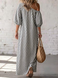 Back view of grey striped maxi dress with exposed shoulder and puff sleeves