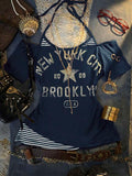 Front flat lay of navy layered graphic T-shirt with striped halter insert and New York print