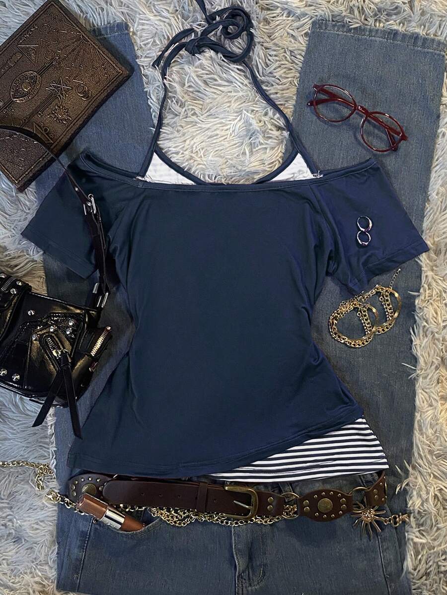Back flat lay of navy off-shoulder top with striped halter ties and layered hem