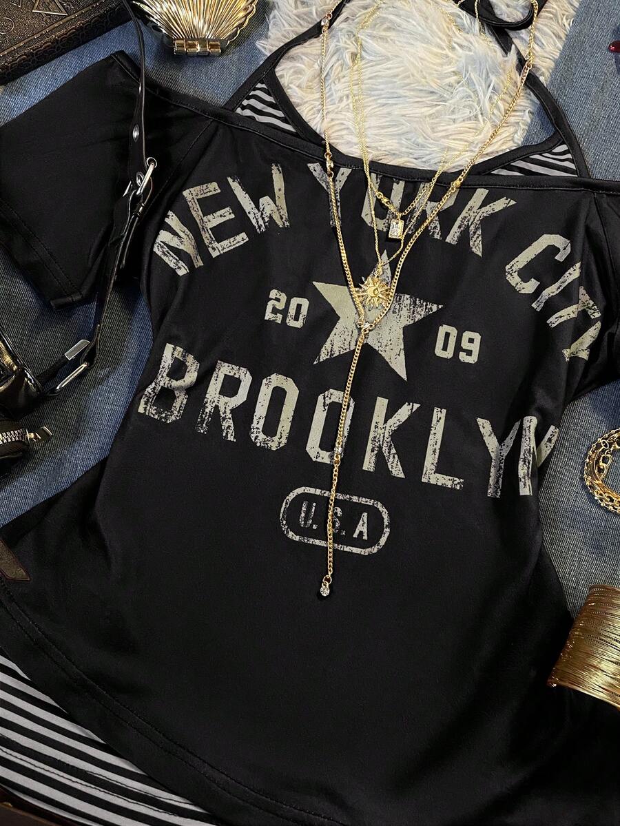 Close-up of black New York graphic top with distressed Brooklyn lettering and star motif