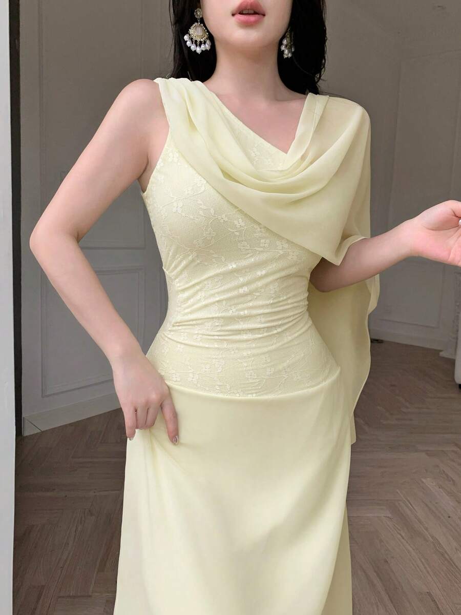Close detail view of pale yellow asymmetrical draped chiffon maxi dress showing visible color, trim, and silhouette