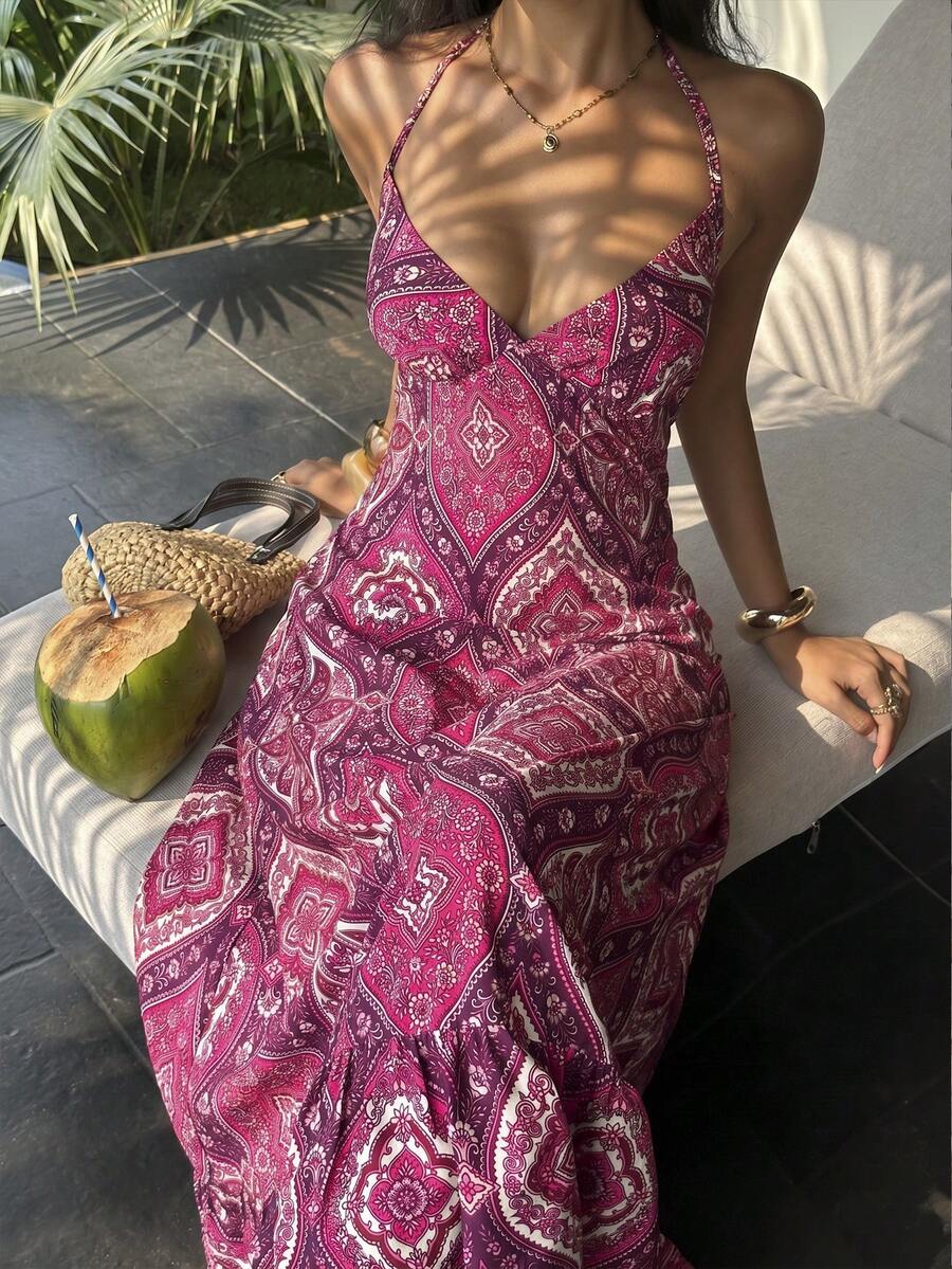Pink paisley halter maxi dress seated front view with coconut and woven bag