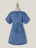 Back view of medium-wash denim mini dress showing concealed zipper and short kimono sleeves