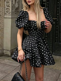 Black polka dot puff sleeve mini dress with chain bag