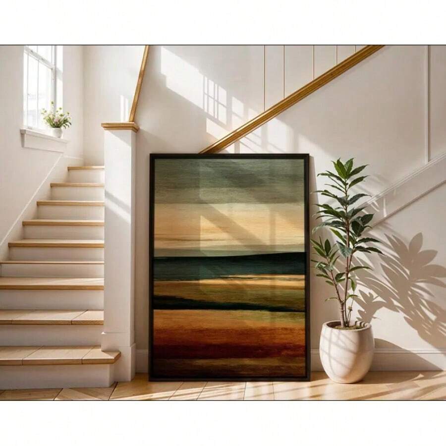 Stairwell view of framed earth tone abstract wall art leaning beside plant