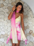 Close detail view of pink yellow floral scarf mini dress showing visible color, trim, and silhouette