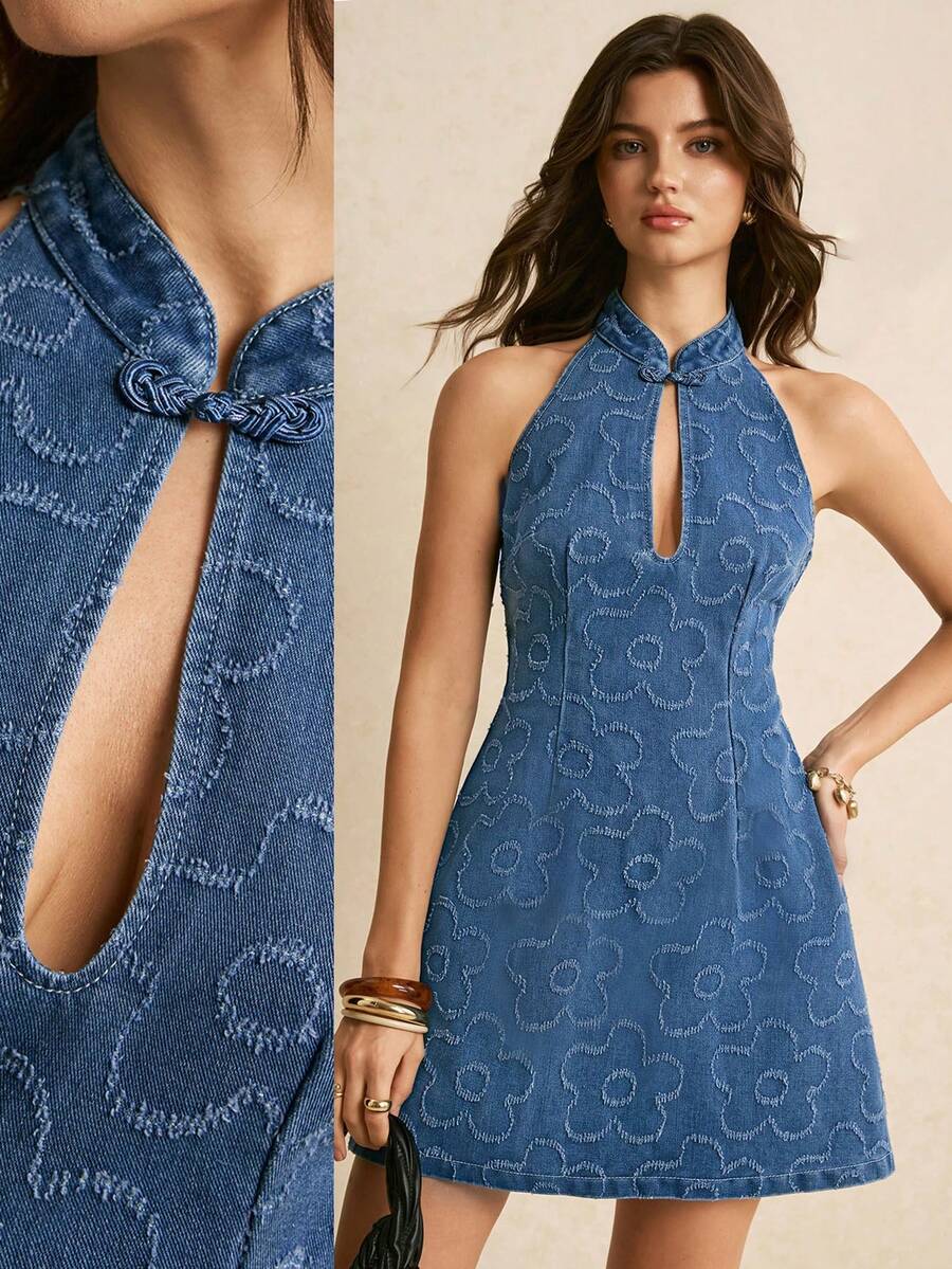 Front view blue denim halter mini dress with keyhole cutout, frog closure, and raised floral pattern