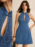Split detail and front view denim halter mini dress showing collar knot and floral texture
