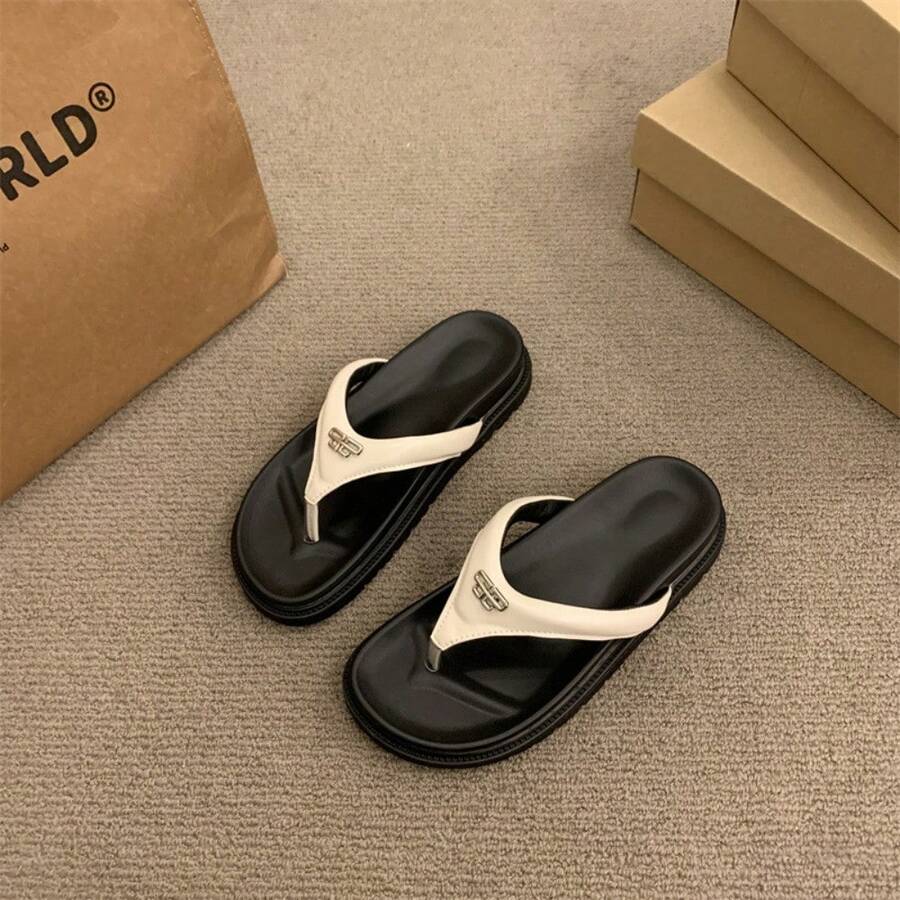 6 media show thong flip-flop slide sandals in cream strap on black sole, all black, and metallic silver strap on black sole with V-shaped toe post strap, broad padded upper, thick black contoured footbed/outsole, small gold metal logo plaque. image 1