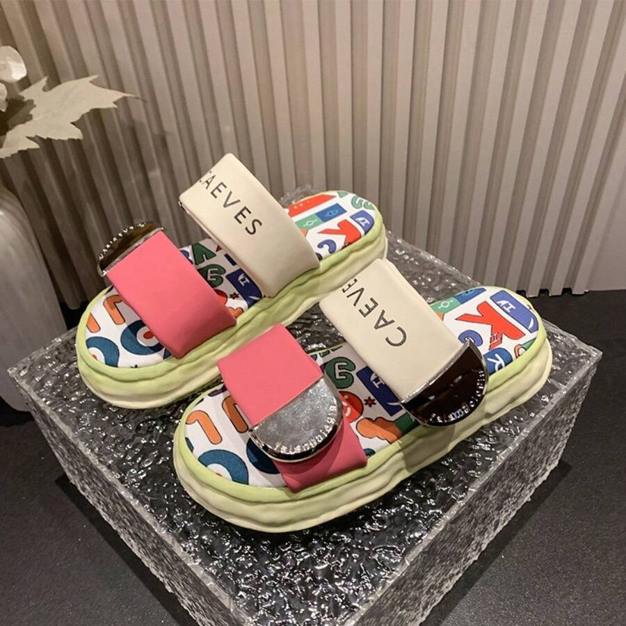 4 media show chunky platform slide sandals with cream, pink and green padded bands, pastel yellow-pink wavy sole, multicolor letter-print footbed, CAEVES text, shiny silver side hardware. image 1