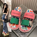 4 media show chunky platform slide sandals with cream, pink and green padded bands, pastel yellow-pink wavy sole, multicolor letter-print footbed, CAEVES text, shiny silver side hardware. image 3