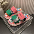 4 media show chunky platform slide sandals with cream, pink and green padded bands, pastel yellow-pink wavy sole, multicolor letter-print footbed, CAEVES text, shiny silver side hardware. image 4