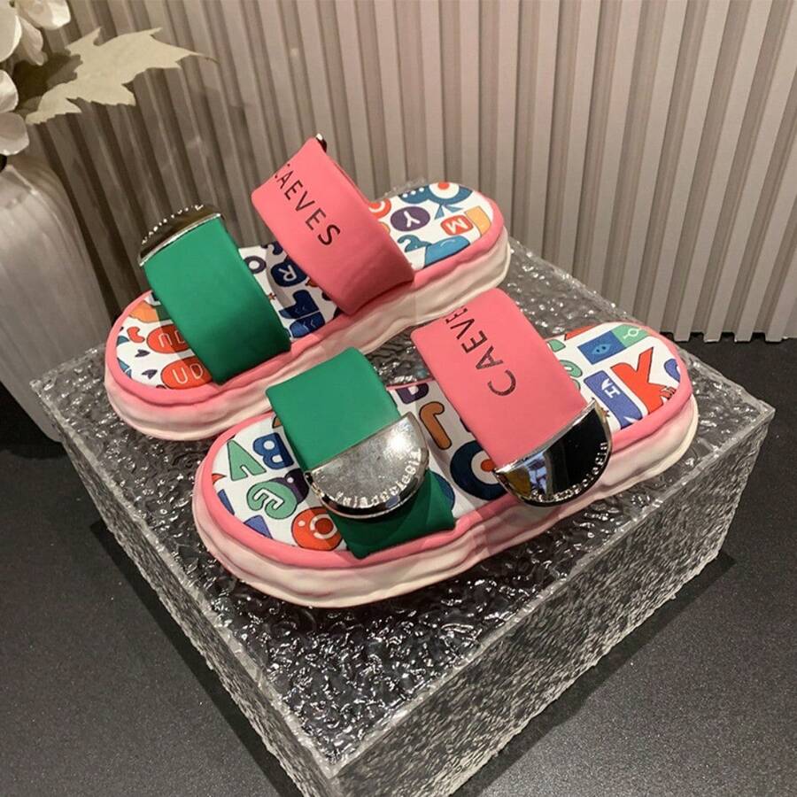 4 media show chunky platform slide sandals with cream, pink and green padded bands, pastel yellow-pink wavy sole, multicolor letter-print footbed, CAEVES text, shiny silver side hardware. image 4