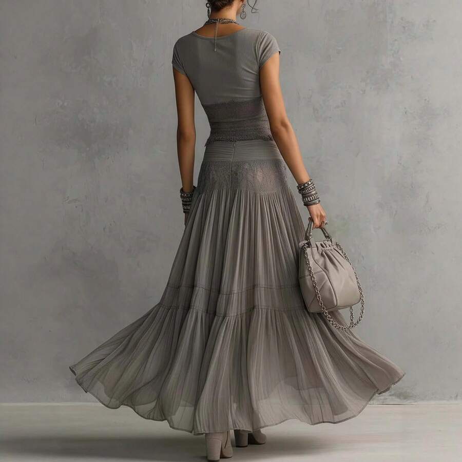 Gray boho two-piece set with ribbed fringe crop top and sheer pleated maxi skirt